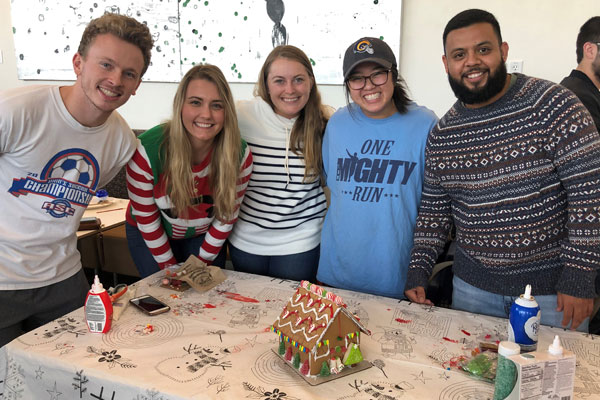 Professional Program in Accounting students work on their gingerbread house.